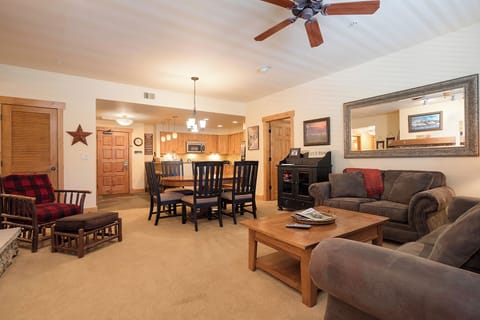 Settle into your cozy living area with plush seating, natural wood accents, and an open layout flowing into the kitchen—your perfect retreat for relaxation and memorable evenings together.