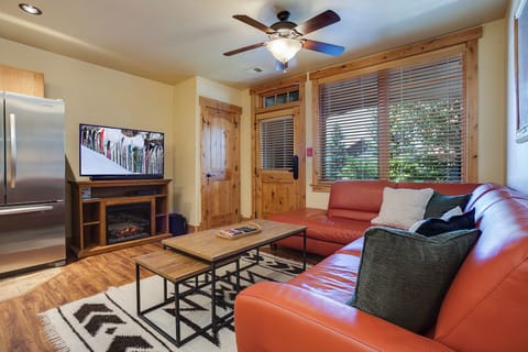 Cozy up on comfortable seating with your favorite shows, warmed by the flickering fireplace as sunlight filters through the blinds.