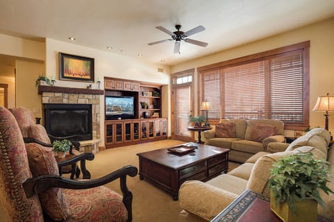 Sink into plush seating by the fireplace, your perfect retreat after a day of adventure. This welcoming space invites you to unwind with your favorite shows or simply enjoy the warm ambiance.