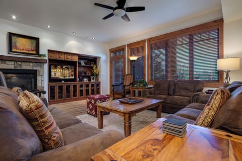 Sink into plush sofas and unwind in your welcoming living room, where warm wood tones, a cozy fireplace, and mountain views create the perfect retreat after a day of adventure.