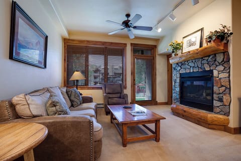 Curl up on the plush sofa and let the warmth of your private fireplace embrace you after a day of adventure. The inviting living room combines rustic charm with modern comfort.