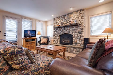Gather here after a day of adventure. Sink into plush leather seating beside a glowing stone fireplace, where warmth and mountain charm invite you to unwind completely.