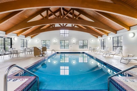 Heated indoor pool with lounge chairs — open year-round for guests to enjoy