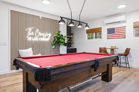 The spacious game room features a pool table, plenty of room to hang out and entertainment for your whole group