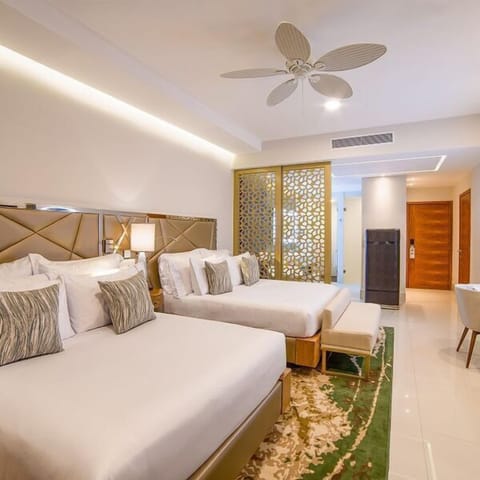 Bright modern room with two plush beds, warm lighting, and stylish design