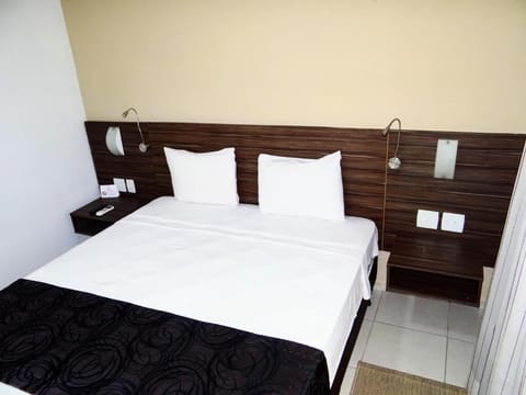 Recharge in a bright, minimalist room with fresh white bedding.