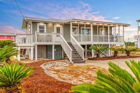 Arrive to a stunning coastal escape glowing under a breathtaking pink-and-blue twilight sky.