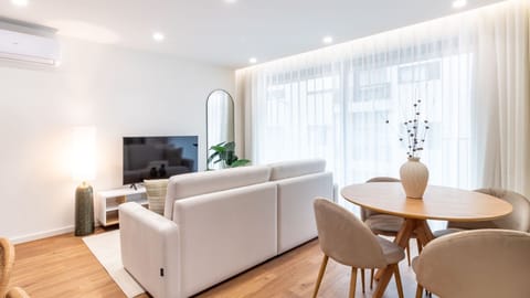 Unwind in the inviting living room, where natural light floods the space, perfect for lounging on the sofa after a day of exploration or enjoying your favorite shows on the large screen TV. The thoughtful design ensures both comfort and convenience throug