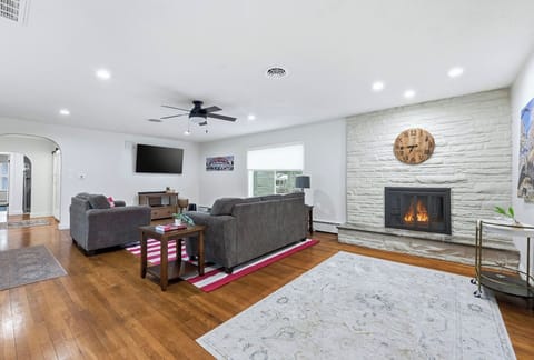 Warm up by the fireplace in this spacious Fort Wayne living room designed for group game nights and catching up after a busy day out.