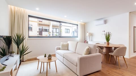 This bright and inviting open-plan living and dining area is designed for comfort and connection, offering a perfect spot to relax on the plush sofa or share a delightful meal around the modern dining table. Enjoy the gentle city hum from the large window