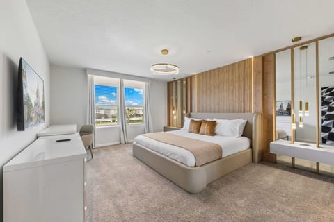 Relax in this stylish king bedroom with warm wood accents, soft neutral tones, and a bright workspace for a comfy, modern retreat.