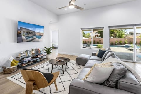 Vaulted, light-filled living room that opens straight out to the pool and backyard through large sliding glass doors