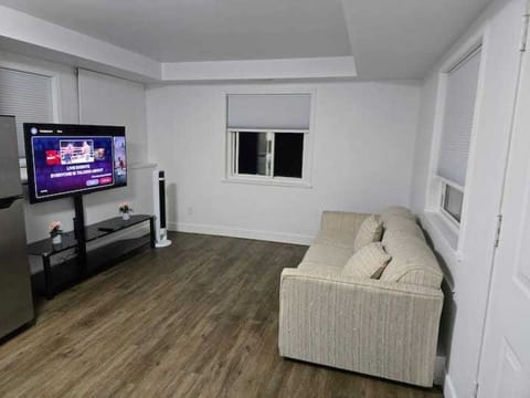 living room with a queen pullout couch and foldable single rolling bed