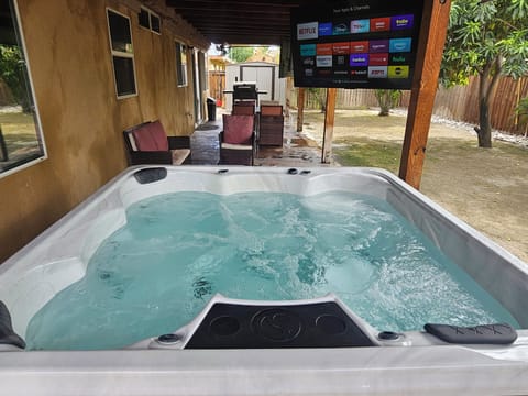 Relax in the private hot tub while enjoying the outdoor TV.