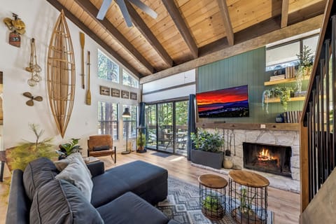 Step into your mountain retreat, where soaring wood-beam ceilings and a stone fireplace welcome you. Sink into the cozy sectional and let the warm glow create your perfect evening.