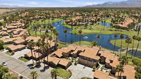 Aerial view showcasing the beautifully landscaped golf course community and surrounding lakes.