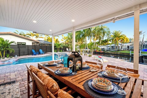 Covered waterfront patio with poolside dining and tropical resort vibes