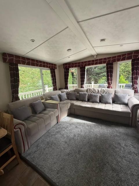 Bright lounge with wraparound sofa and lovely garden views