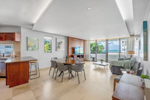 Large open space kitchen, living, dining with ocean view.