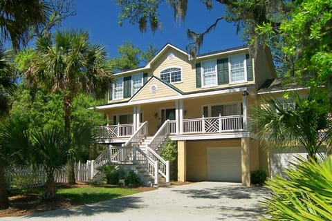Front of home facing Nighthawk Street, with rocking chairs and breakfast table.