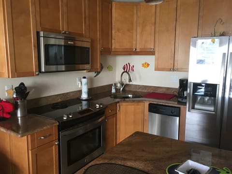 Gourmet kitchen with plenty of cooking utensils, pots, etc.