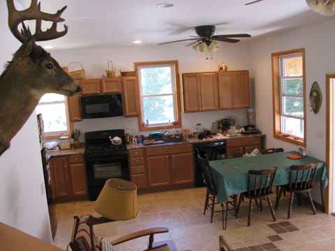kitchen and dining table now w/ 6 chairs, 5 burner stove, microwave, dishwasher