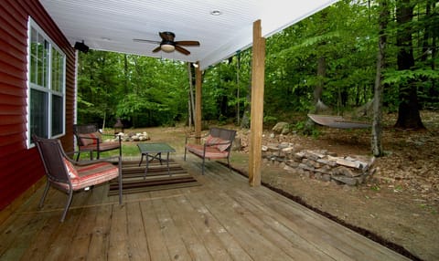 Covered outdoor seating, hammock, and firewood (provided).