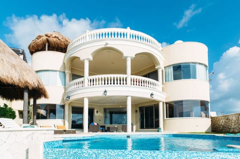 Villa Escapar ocean front view with negative edge poos and palapas on the beach