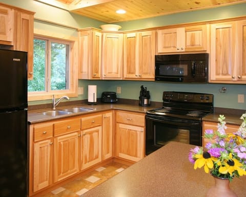 Fully equipped kitchen with solid surface countertops and ceramic tile floors.