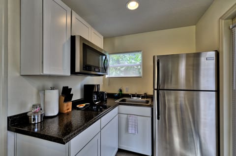 Kitchen with glass top burner, coffee maker, convection microwave, sink & etc
