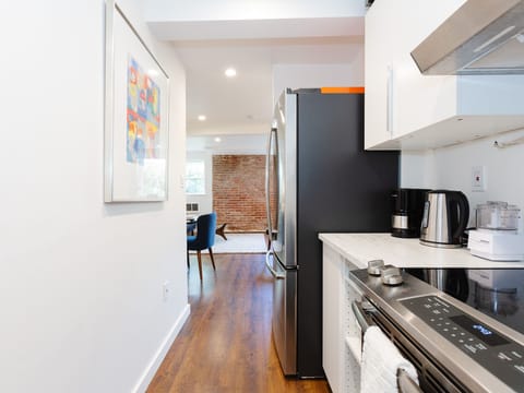 Fully equipped kitchen with large size appliances, refrigerator, range and oven.