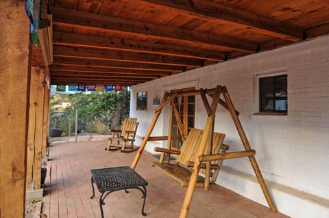 swinging bench and rocking chair on front porch
