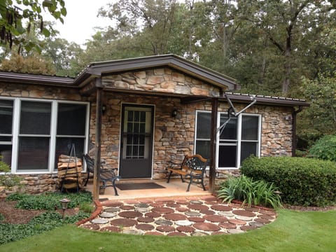Front of house facing lake and lush front lawn.