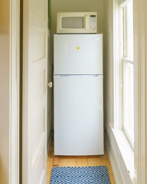 The fridge is in its own funny nook.