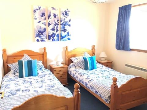 Twin Bedroom with ample storage and electric panel heater.