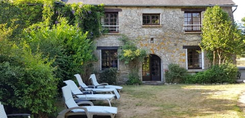 Just half of the front of house with lawn with badminton and croquet