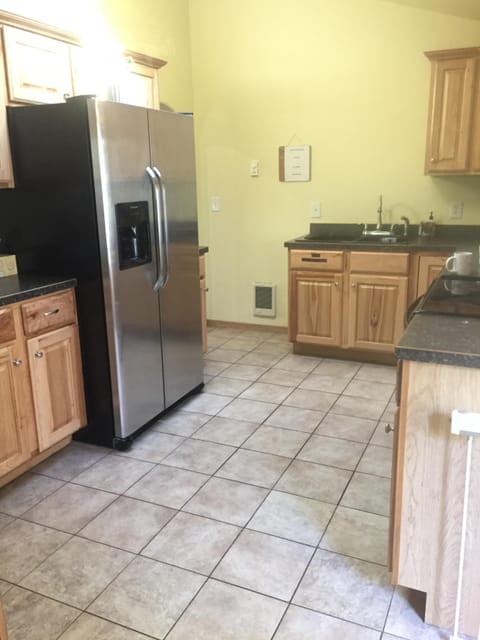 Kitchen well stocked with an assortment of pans, spices, dishes and glassware