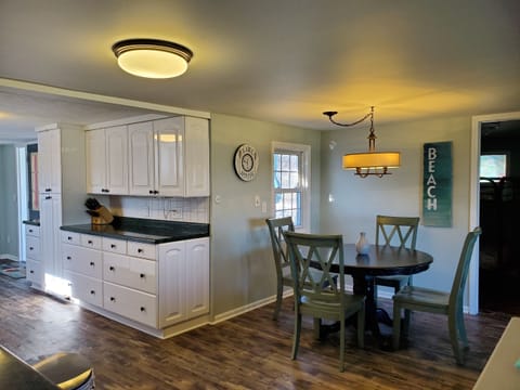 Dining area with 4 chairs. Additional dining space in sunroom.
