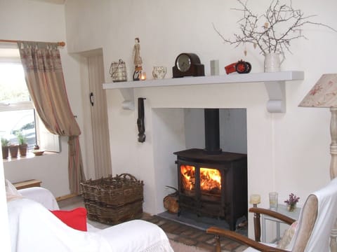 Sitting Room. Traditional Multifuel Stove, Turf Creel & Swiss Cow Bell. Cosy !!