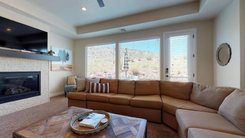 Family room featuring large flat screen tv with door to patio