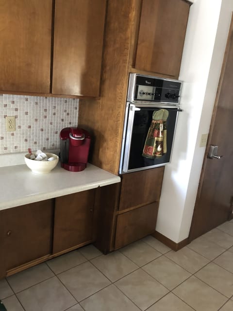 Keurig coffee maker, builit in oven, door to lower level.