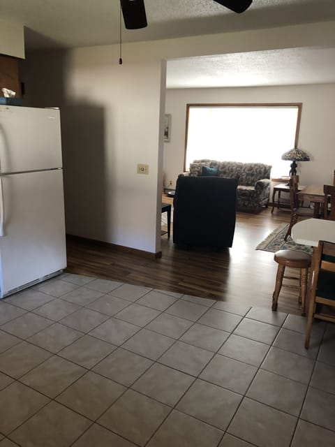 Kitchen looking into living room. Tile floor in kitchen.