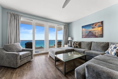 nviting living room with plush seating and stunning floor-to-ceiling views of the emerald Gulf.