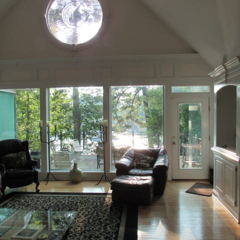 Living room with a wall of windows with breath taking lake views