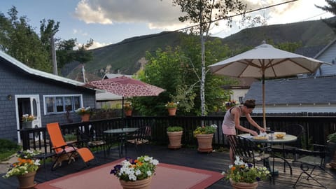 Guest enjoying deck. Grey building is Carriage House where I sometimes stay.