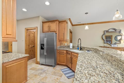 Granite kitchen counters with travertine tile floors and stainless steel