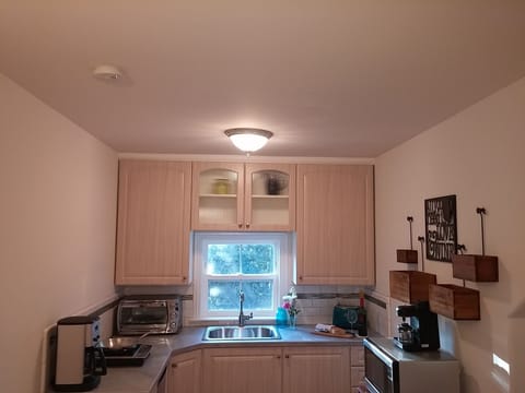 Kitchen w/ microwave, induction cooktop, toaster oven,  coffee & espresso makers