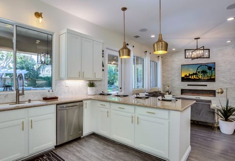Remodeled kitchen with stainless steel appliances, granite countertops, double oven and marble chevron backslash for a fun and inviting feel