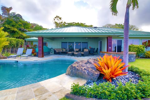 Great shot of the pool , landscaping and lanai 