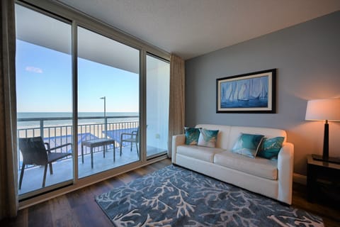 Bright living area with ocean view, stylish decor, and cozy seating.